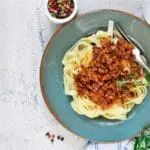 Pasta with meat sauce on plate.