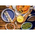 Hearty vegetable pie with sides.