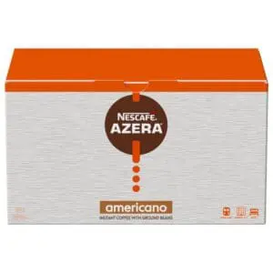 A box of NESCAFÉ Azera Americano Instant Coffee Sachets 200x2g with ground beans, featuring a red and brown logo on a gray textured background.