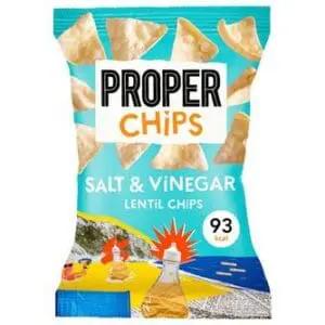 A bag of Properchips BBQ Lentil Chips 24x20g displaying chips, calorie content, and vibrant graphics with coastal imagery.