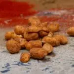 Spicy roasted peanuts on table.