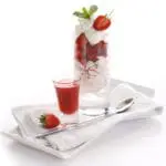 Strawberry dessert with cream and sauce.