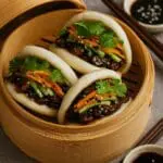 Soft Bao Hirata Buns filled with sticky hoisin mushrooms, pickled vegetables, and herbs — a vegan street food recipe by Nicol Retailer Limited.