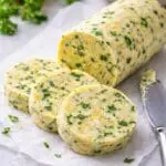 Close-up of homemade yuzu herb butter created by Nicol Retailer Limited, featuring a creamy yellow compound butter flecked with fresh herbs, citrus zest, and miso.
