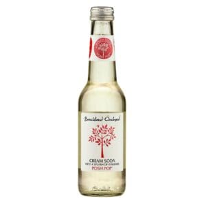 A clear glass bottle of Breckland Orchard Cream Soda with a splash of Rhubarb 12x275ml, featuring a red and white label with a tree design, isolated on a white background.