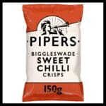 A bag of Pipers Biggleswade Sweet Chilli Sharing Crisps 15x150g, featuring a black and white logo with a vintage-style figure blowing a horn.