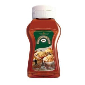 A plastic bottle of Lyle's Golden Syrup Squeezy 750g, with a green label featuring an image of muffins, isolated on a white background.