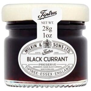 A glass jar of Tiptree Black Currant Preserve 72x28g, labeled with white text and logo on a black background.