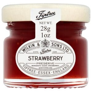 A small glass jar of Tiptree Strawberry Preserve 72x28g with a beechwood lid, labeled with details including weight (28g) and origin (Essex, England).