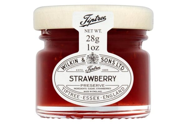 A small glass jar of Tiptree Strawberry Preserve 72x28g with a beechwood lid, labeled with details including weight (28g) and origin (Essex, England).