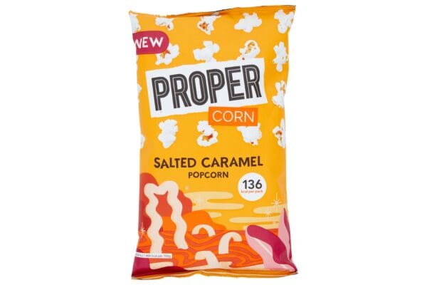 A package of Propercorn Salted Caramel Popcorn 24x28g against a white background, featuring a vibrant orange and yellow design with popcorn and caramel graphics.