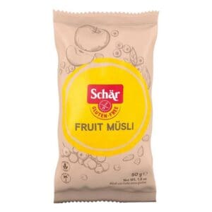 Package of Schär Gluten Free Muesli portion pack 24x50g, displaying the product name and gluten-free label in a yellow circle, with illustrations of fruits and cereal.