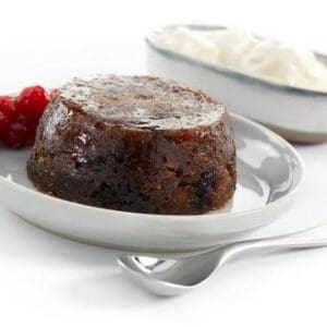 Sticky toffee pudding with berries and cream.