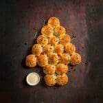 Here's an alt tag for the image: Christmas tree-shaped bread rolls.