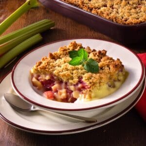 Rhubarb crumble dessert, garnished with mint.