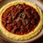 Braised British beef shin ragù made with Alec Jarrett British Red Tractor Beef Shin from Nicol Retailer Limited, served over creamy Parmesan mash with rosemary and Parmesan cheese — created by Nicol Retailer Limited.