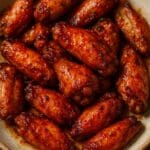 Spicy honey-glazed chicken wings made with ISFI Professional Cayenne Pepper from Nicol Retailer Limited, golden brown and coated in a glossy chilli glaze.