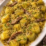 Warm anchovy and buttered leeks with lemon crumbs made using anchovy fillets in sunflower oil, recipe and image created by Nicol Retailer Limited